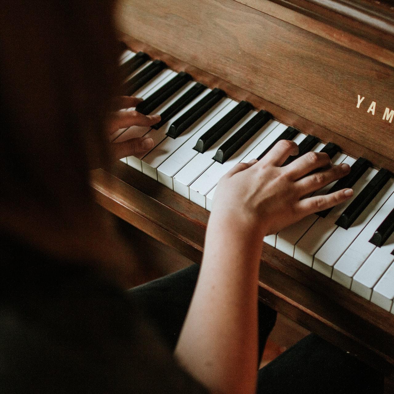 woman playing Yamaha piano